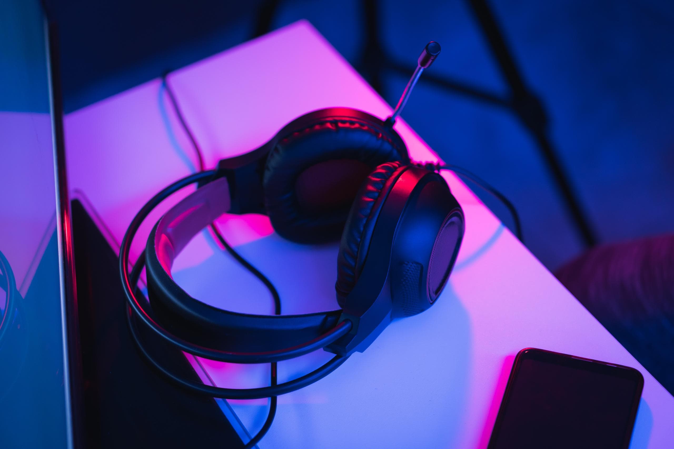 Black headphones under purple light